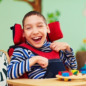 Laughing boy in wheelchair