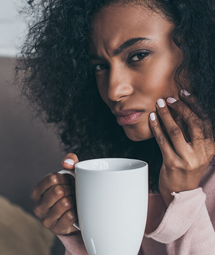 Woman in pain after drinking hot beverage