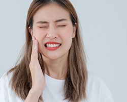 woman experiencing slight dental pain